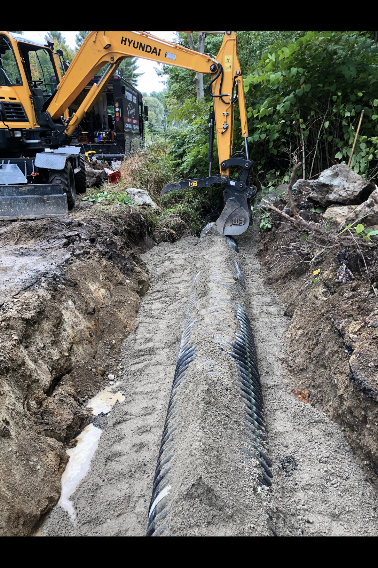 Pittore Brothers Paving crew and equipment laying fresh asphalt in Southern NH